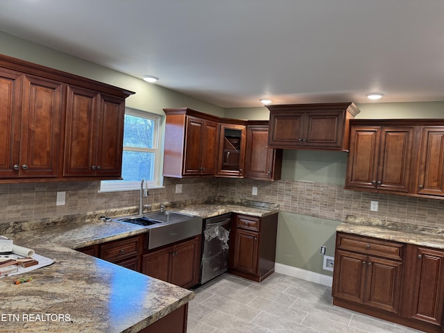 kitchen with decorative backsplash, black dishwasher, light tile patterned flooring, and sink