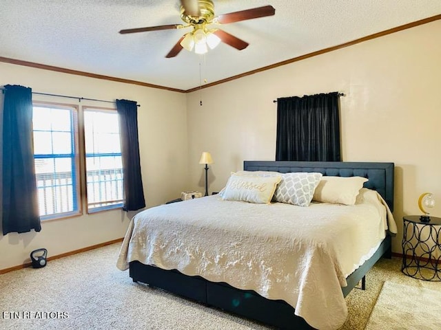 bedroom with ceiling fan, carpet floors, and a textured ceiling