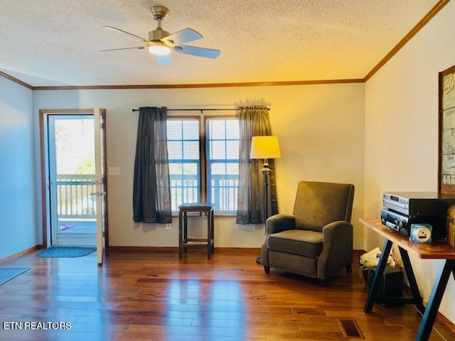 living area featuring ceiling fan, dark hardwood / wood-style flooring, and a textured ceiling