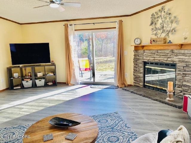 living room with a fireplace, a textured ceiling, hardwood / wood-style flooring, and ceiling fan