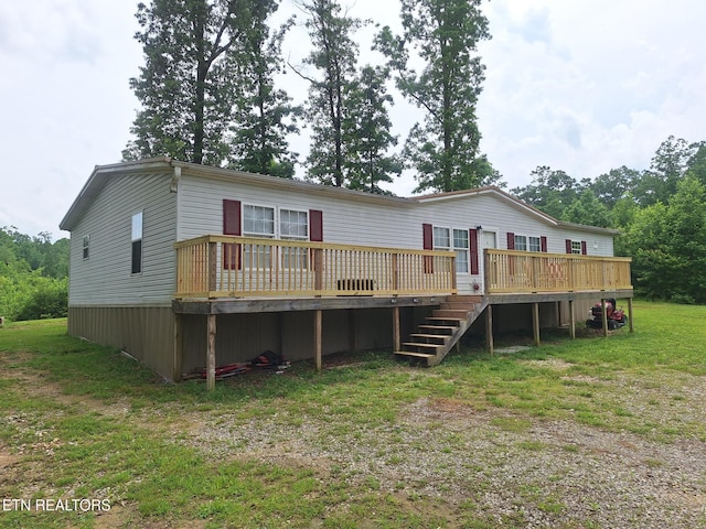 back of house with a yard and a deck