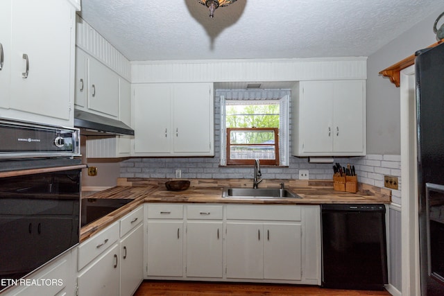 kitchen featuring white cabinets, a textured ceiling, black appliances, and sink