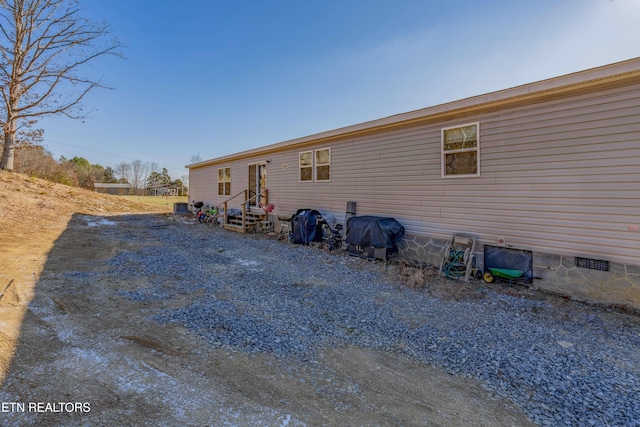 back of house with crawl space and entry steps