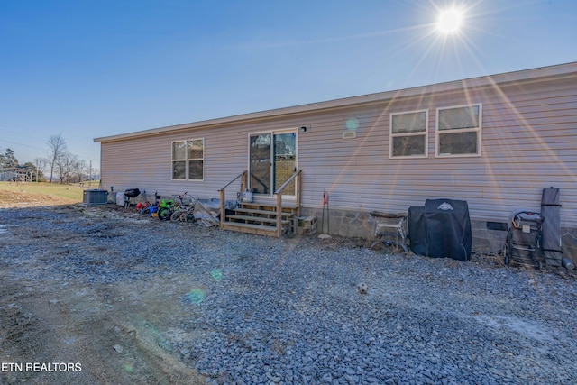 view of front of home featuring crawl space, cooling unit, and entry steps