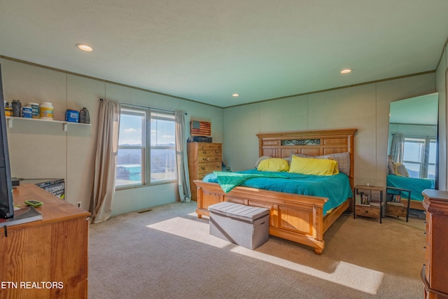 carpeted bedroom featuring recessed lighting, visible vents, and ornamental molding