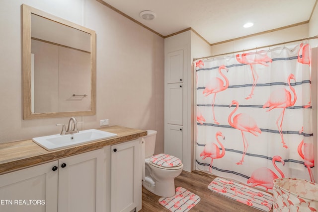 bathroom with vanity, a shower with curtain, wood finished floors, crown molding, and toilet