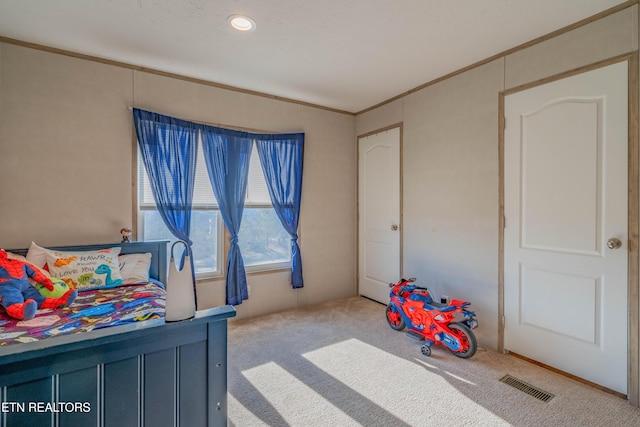 bedroom with visible vents, carpet floors, and ornamental molding