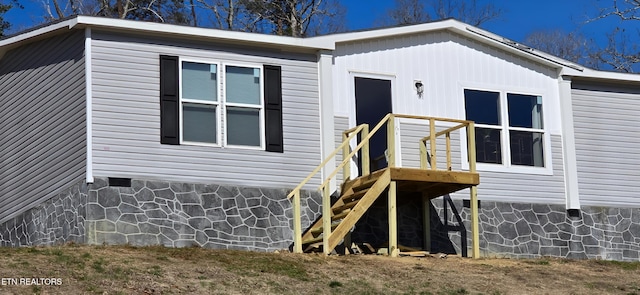 exterior space with crawl space and stairs