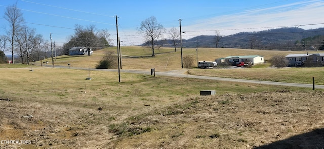 view of yard with a rural view