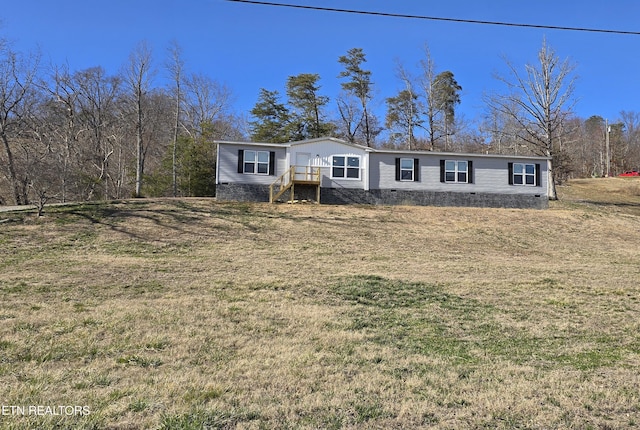 manufactured / mobile home featuring a front lawn and crawl space