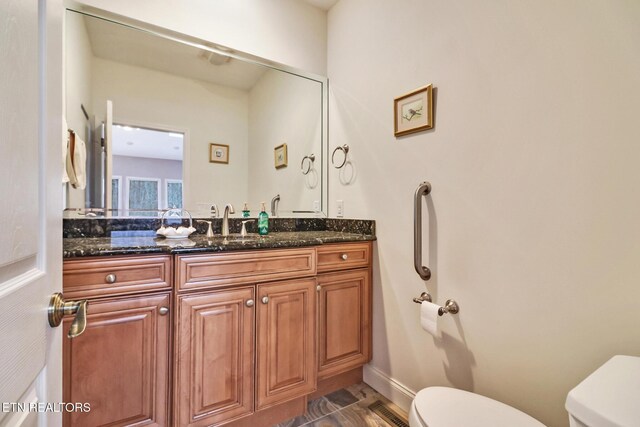 bathroom with vanity and toilet