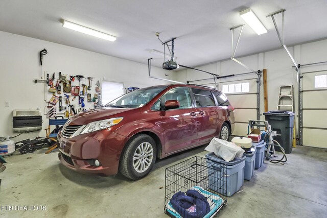 garage with a garage door opener and heating unit