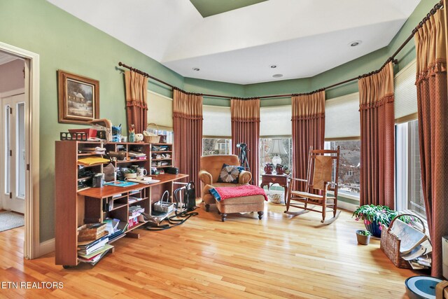 sitting room featuring hardwood / wood-style flooring and a healthy amount of sunlight