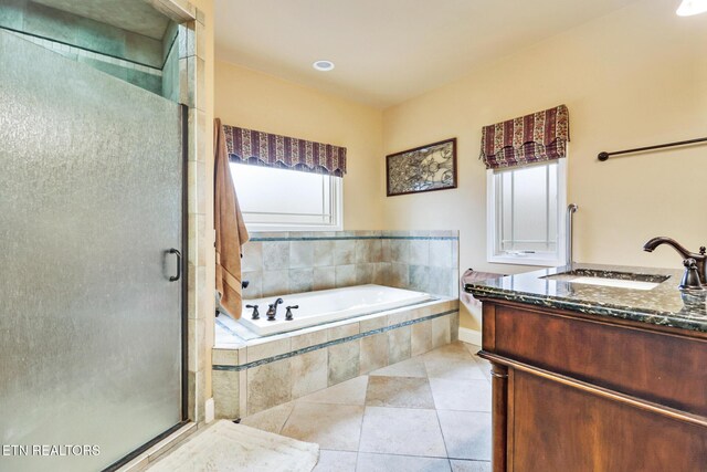 bathroom featuring tile patterned floors, vanity, and separate shower and tub