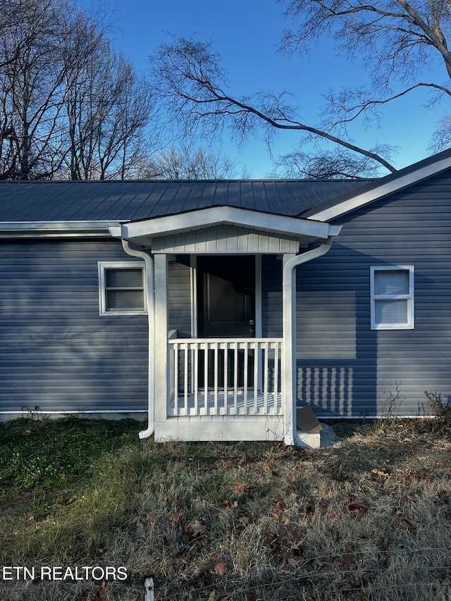 view of exterior entry with a porch