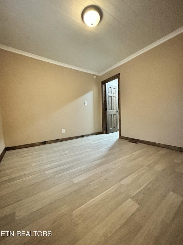 unfurnished room featuring light hardwood / wood-style floors and ornamental molding