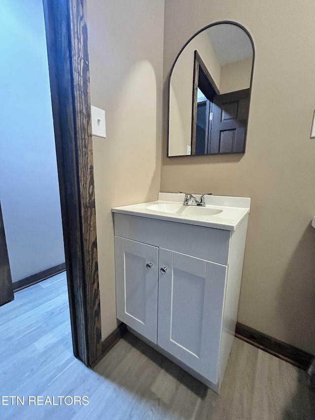 bathroom with hardwood / wood-style flooring and vanity