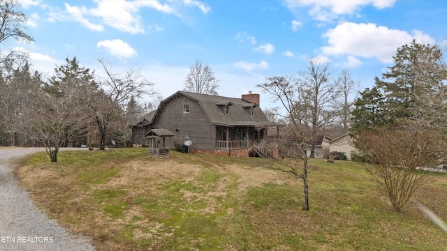 view of side of home with a lawn