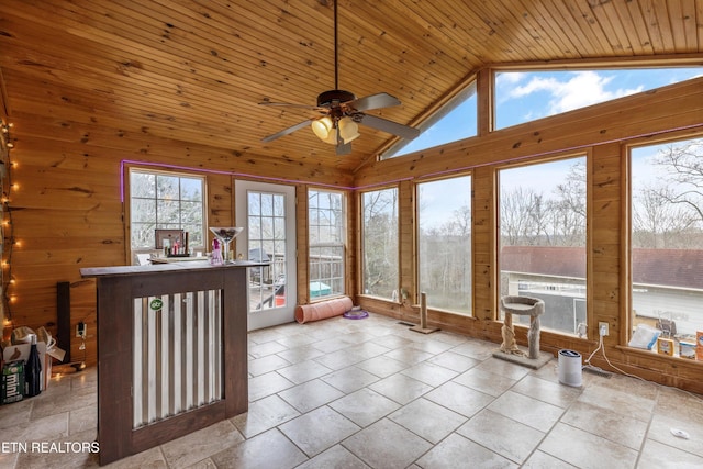 unfurnished sunroom with a healthy amount of sunlight, ceiling fan, lofted ceiling, and wood ceiling