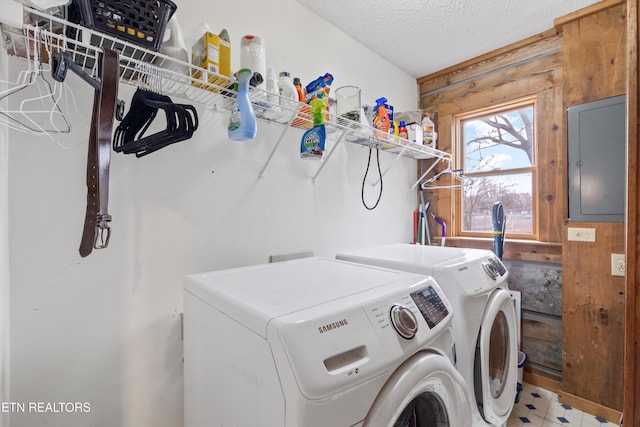 laundry room featuring washer and clothes dryer and a textured ceiling