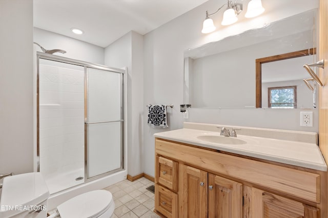 bathroom featuring vanity, toilet, and walk in shower