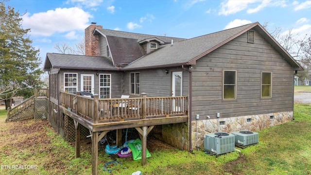 rear view of house with a lawn, central AC unit, and a deck