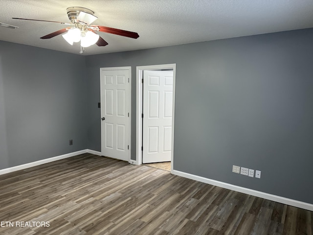 unfurnished bedroom featuring hardwood / wood-style flooring, ceiling fan, and a textured ceiling