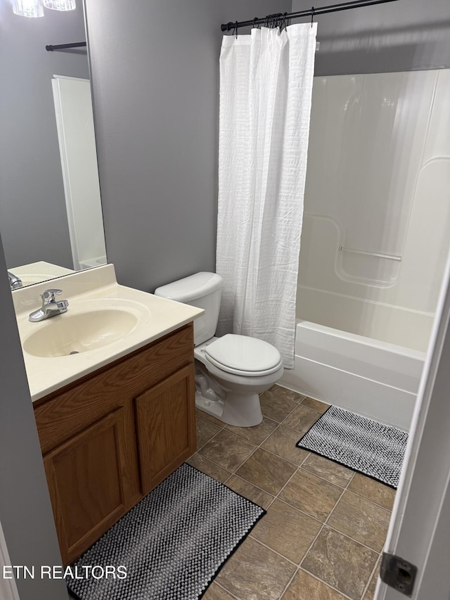 full bathroom with vanity, shower / bath combination with curtain, and toilet