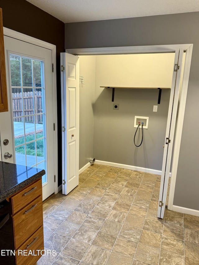 washroom with hookup for a washing machine, plenty of natural light, and electric dryer hookup