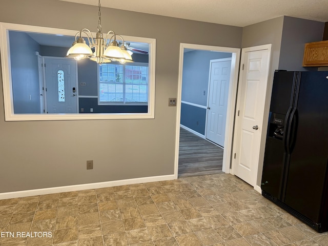 unfurnished dining area featuring an inviting chandelier