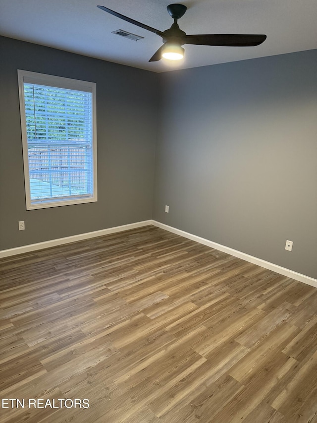 spare room featuring ceiling fan and wood-type flooring