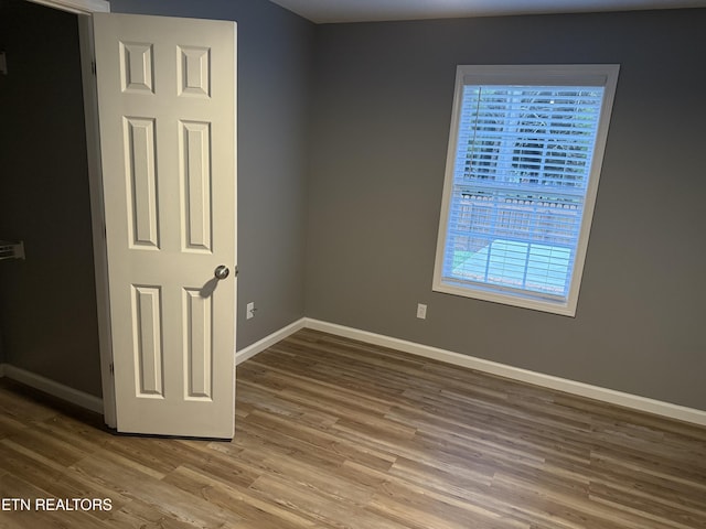 unfurnished room featuring hardwood / wood-style floors