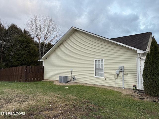 view of side of property with a lawn