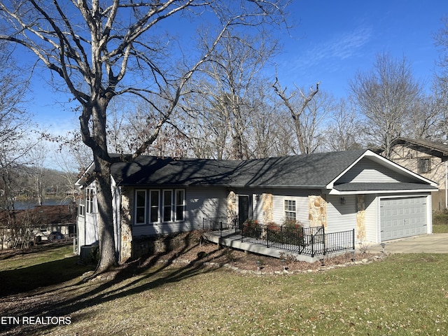 single story home with a front yard and a garage