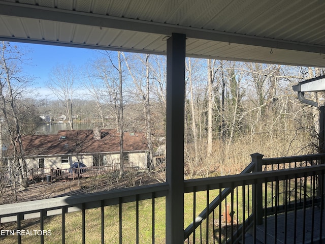 wooden deck featuring a lawn