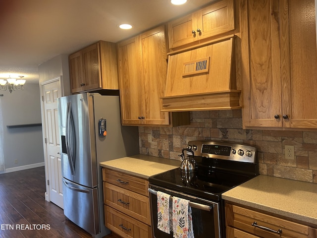 kitchen with an inviting chandelier, dark hardwood / wood-style flooring, decorative backsplash, custom range hood, and appliances with stainless steel finishes