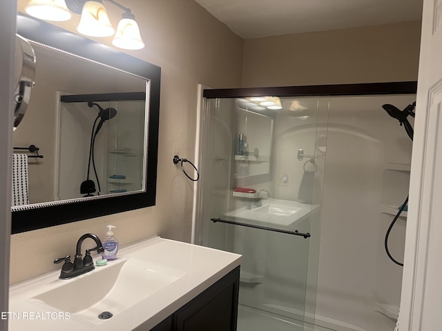 bathroom featuring vanity and an enclosed shower