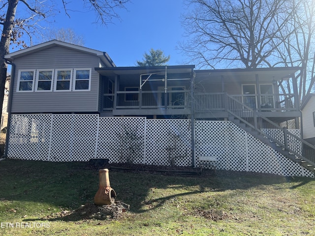 rear view of property featuring a yard