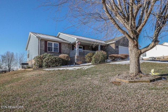 ranch-style home featuring a porch, a front lawn, and a garage