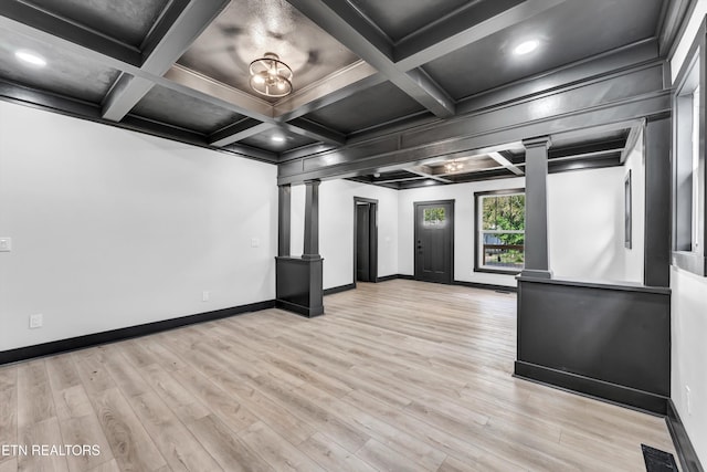 interior space featuring beam ceiling, ornate columns, coffered ceiling, crown molding, and light hardwood / wood-style floors