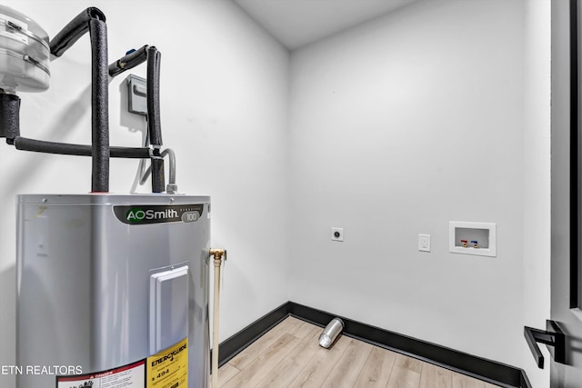 laundry area featuring hardwood / wood-style floors, washer hookup, electric dryer hookup, and water heater