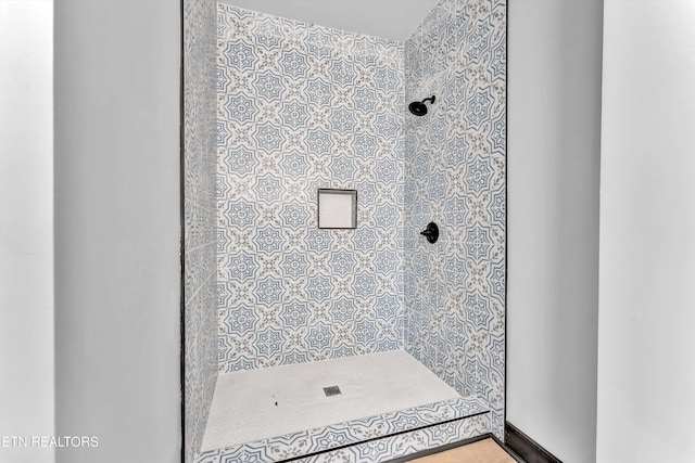 bathroom with tiled shower