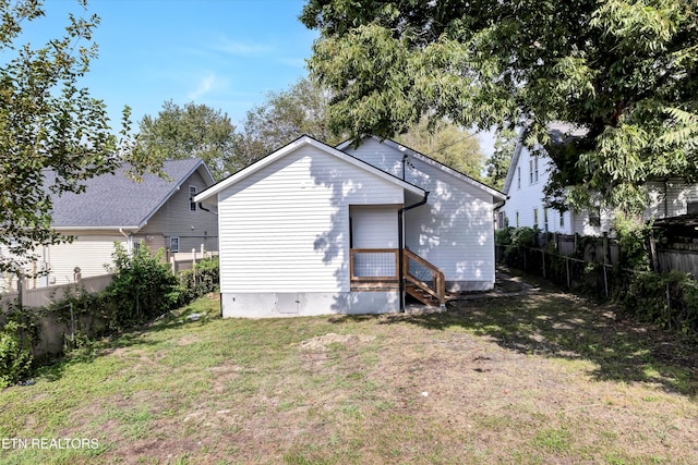 rear view of house with a lawn