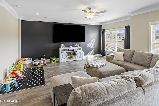 living room featuring hardwood / wood-style floors, ceiling fan, and ornamental molding