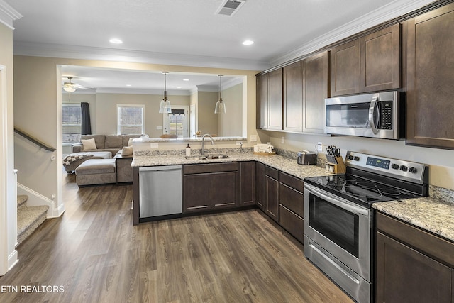 kitchen with hanging light fixtures, sink, ceiling fan, appliances with stainless steel finishes, and kitchen peninsula