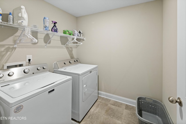 clothes washing area with washing machine and dryer