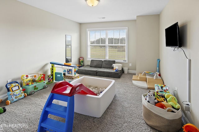 recreation room with carpet flooring