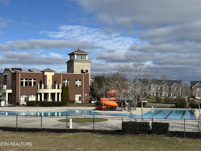 view of swimming pool with a water slide