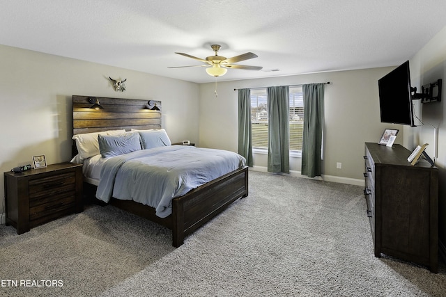 bedroom with a textured ceiling, light colored carpet, and ceiling fan