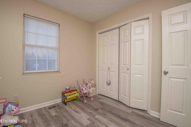 rec room with light hardwood / wood-style floors